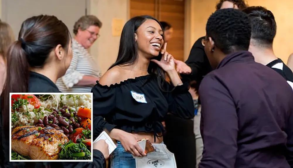 A group of individuals is engaged in conversation at an event with one smiling woman in focus and theres an inset image of a healthy plated meal