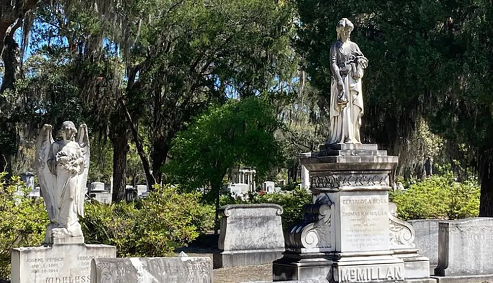 The image shows a peaceful cemetery adorned with statues and Spanish moss-hung trees conveying a serene final resting place