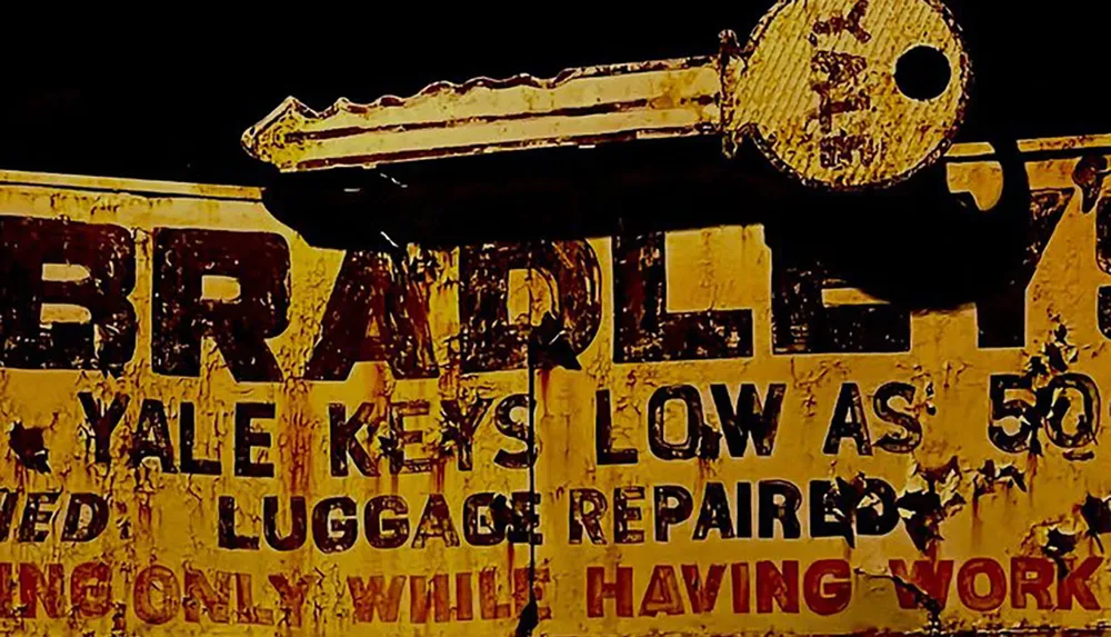 The image displays a worn and deteriorating sign advertising key cutting and luggage repair services with prices starting as low as 50 cents