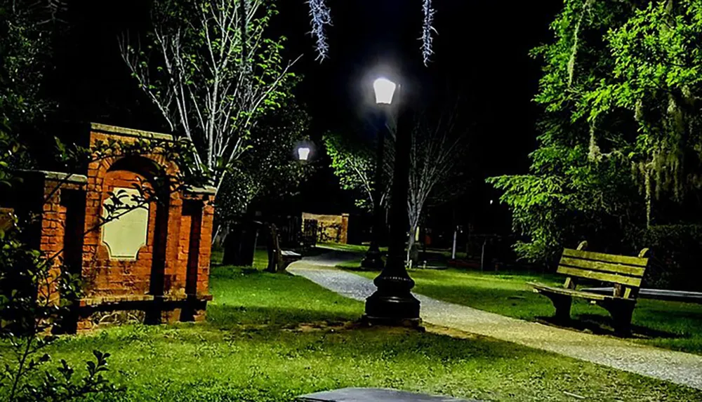 A serene night scene in a park illuminated by street lamps with a winding path a bench and lush greenery