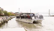 A group of people is enjoying a ride on a riverboat named 