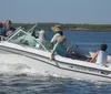 A group of people enjoy a sunny day aboard a white Grady-White motorboat cruising on the water