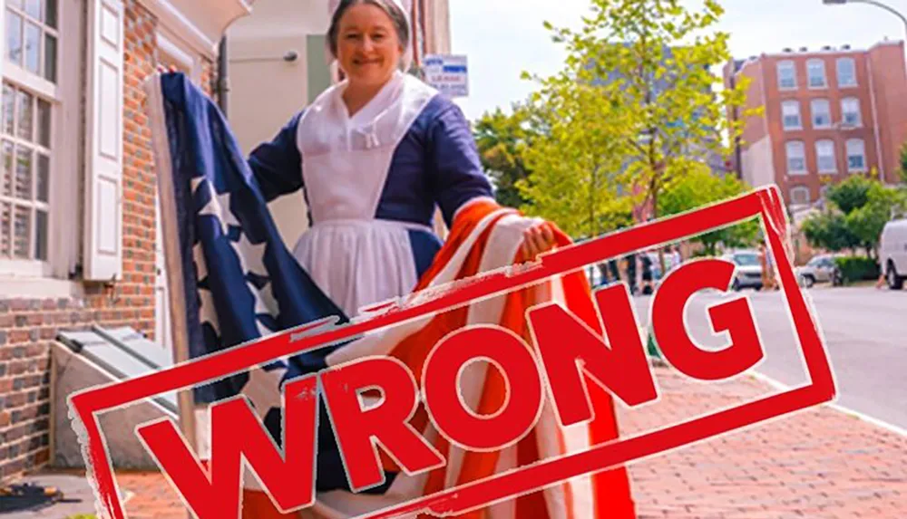 A person dressed in historical clothing handles an American flag on a sidewalk overlaid with a large red stamp reading WRONG