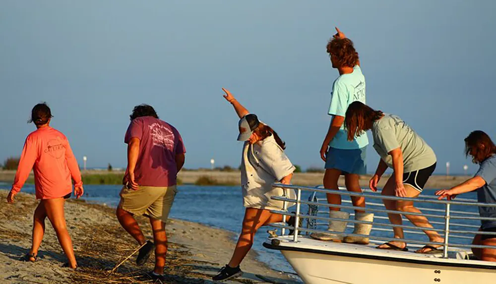 A group of individuals appears to be engaged in a beachside activity with one person pointing into the distance while others look on or work on a boat