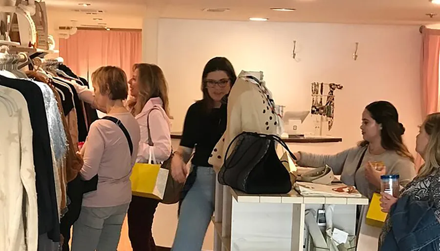 Group of people shopping in a clothing store.