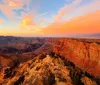 The image is a collage of two contrasting components a majestic canyon under an orange-hued sky and a close-up of a hamburger meal which together could suggest a dining experience with a scenic view