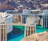 The image shows the Hoover Dam with its distinctive concrete arch-gravity structure flanked by large water intake towers situated in a rugged desert canyon with a reservoir behind it