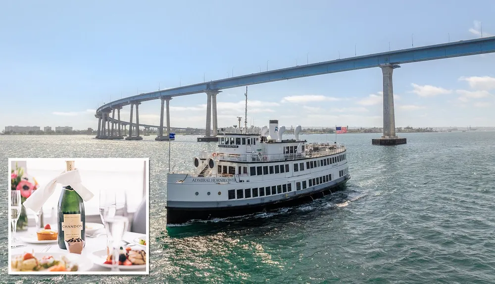 A cruise ship named Admiral Hornblower sails under a large bridge with a scenic shoreline in the background while an inset shows a bottle of Chandon champagne on a table set with food