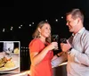 A couple is toasting with wine glasses at a nighttime outdoor setting with a plated dish of food inset in the image