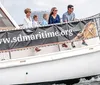 A boat labeled PILOT associated with the Maritime Museum of San Diego is carrying people on the water