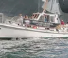 A boat labeled PILOT associated with the Maritime Museum of San Diego is carrying people on the water