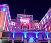 A city tour trolley passes under the Historic Heart of San Diego arch in a vibrant urban setting