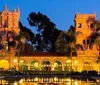 A city tour trolley passes under the Historic Heart of San Diego arch in a vibrant urban setting