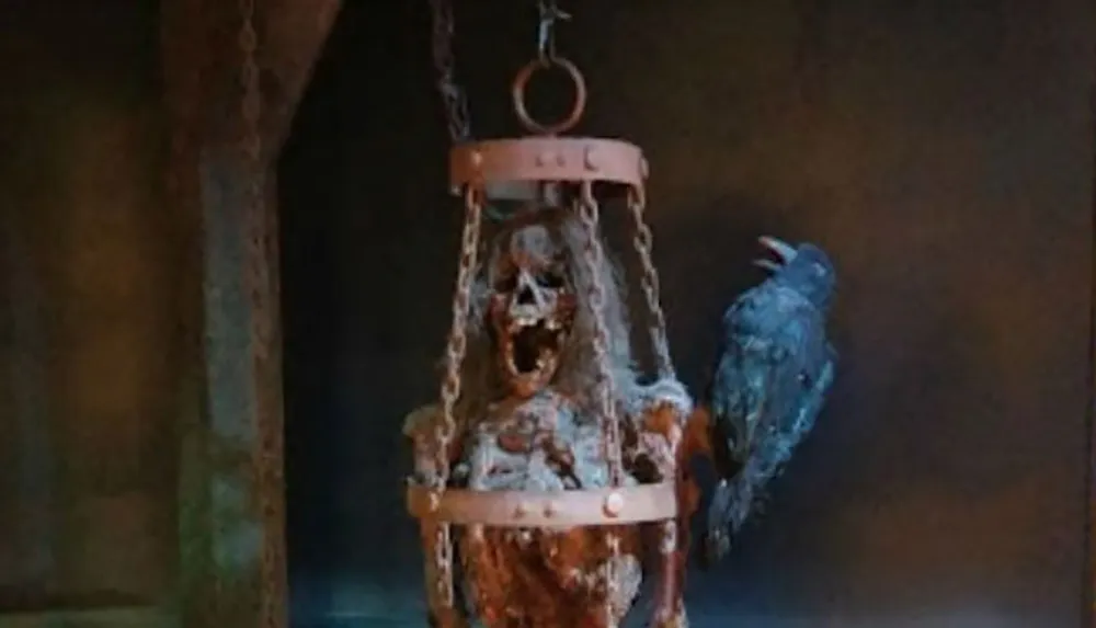 A weathered skeleton with an open-jawed expression hangs in a cage beside a crow