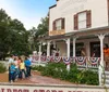 A group of people is riding a tour trolley in a town with historic-looking buildings in the background