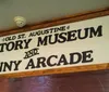 A couple is taking a selfie in front of an antique car inside Gator Bobs Old St Augustine History Museum