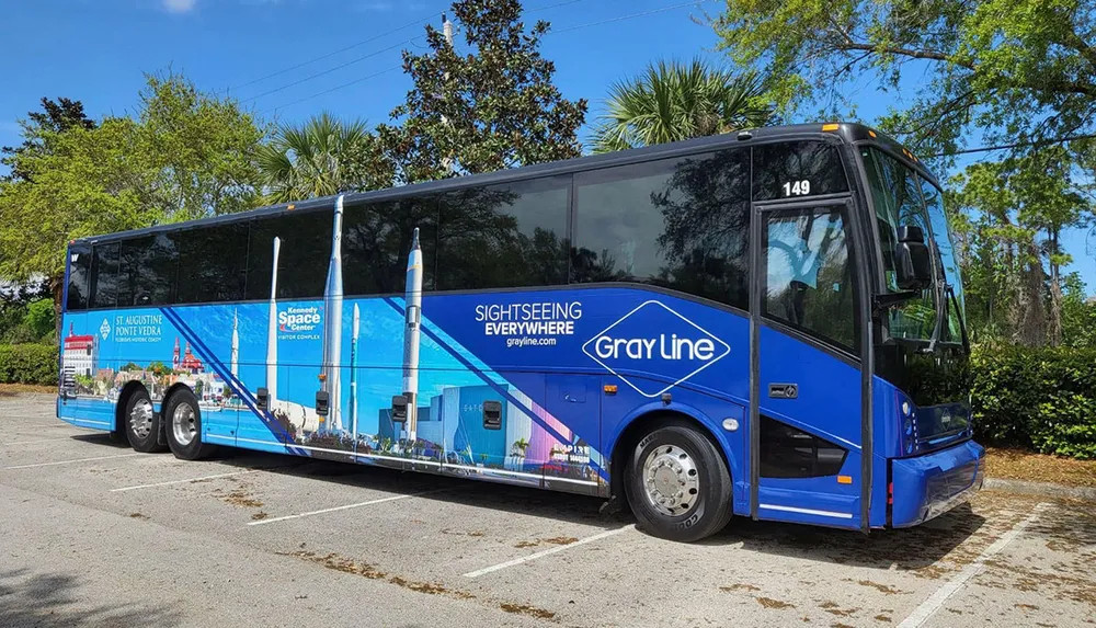 A Gray Line sightseeing tour bus is parked featuring an advertisement for the Kennedy Space Center and St Augustine