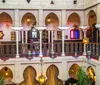 The image depicts an intricately designed multi-level interior space inspired by Middle Eastern architecture featuring arched doorways ornate columns decorative lanterns and vibrant colored accents