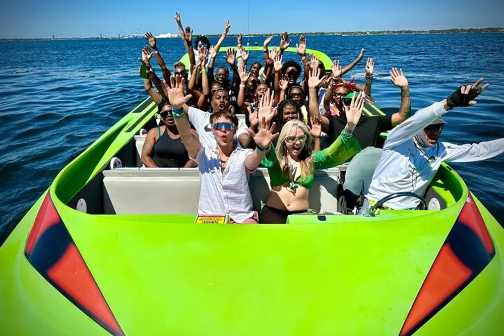 A group of excited people are raising their hands while enjoying a ride on a bright green speedboat