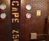 The image displays an industrial-themed room with brick walls featuring a variety of analog gauges a quarantine warning sign and a pillar with text cutouts that cast shadows on the wall