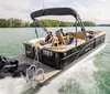 A group of people are enjoying a ride on a modern pontoon boat equipped with a Mercury outboard engine gliding across a tranquil lake