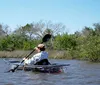 This collage portrays various scenes related to kayaking and nature exploration including a person kayaking a close-up of a kayak paddle two individuals beside their kayaks on a sandy shore a sea creature near the waters edge and an aerial view of kayaks on a curve of a waterway surrounded by greenery