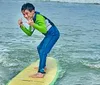 Two children are happily surfing together on a bright sunny day at the beach