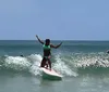 Two children are happily surfing together on a bright sunny day at the beach