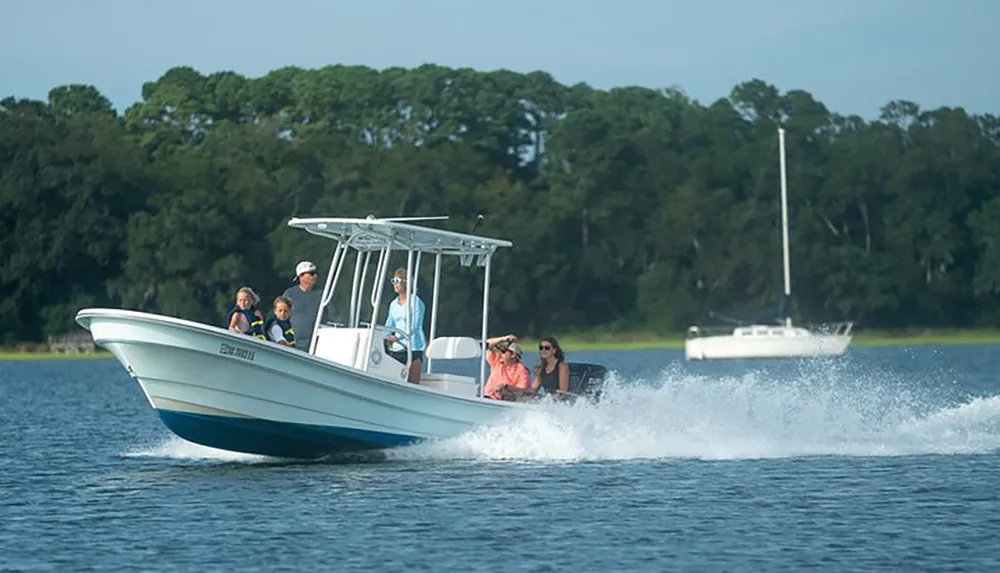 A group of people is enjoying a day out on the water in a motorboat