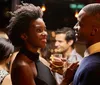 Two people are enjoying a conversation while holding drinks at a social event