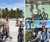 A group of people is enjoying a sunny day riding electric bikes along a palm-lined pathway