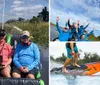 A group of people in matching blue shirts are joyfully raising their hands while on a boat ride under a clear blue sky