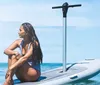 A man and a woman paddleboarding on a calm clear ocean