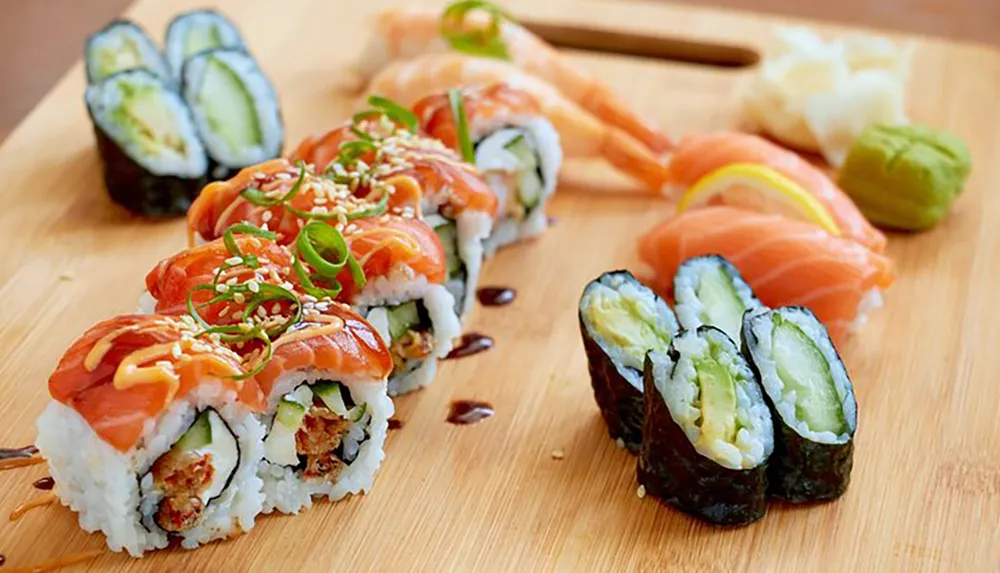 The image shows an assortment of sushi pieces including rolls topped with salmon and avocado served on a wooden board with pickled ginger and wasabi on the side