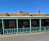 This image is a promotional advert for The Santa Fe VIPs Ultimate History Tour featuring a vintage photograph of cars and buildings with tour details overlaid in text