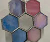 The image shows a collection of hexagonal stained glass panels in various colors assembled together to form a honeycomb-like pattern