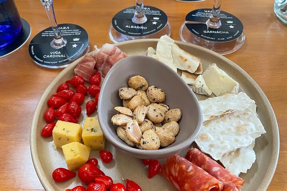 The image showcases a charcuterie board with a variety of cheeses meats almonds and cherry tomatoes accompanied by wine-tasting cards