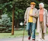 Four senior adults are enjoying a lively conversation while walking together in a green park