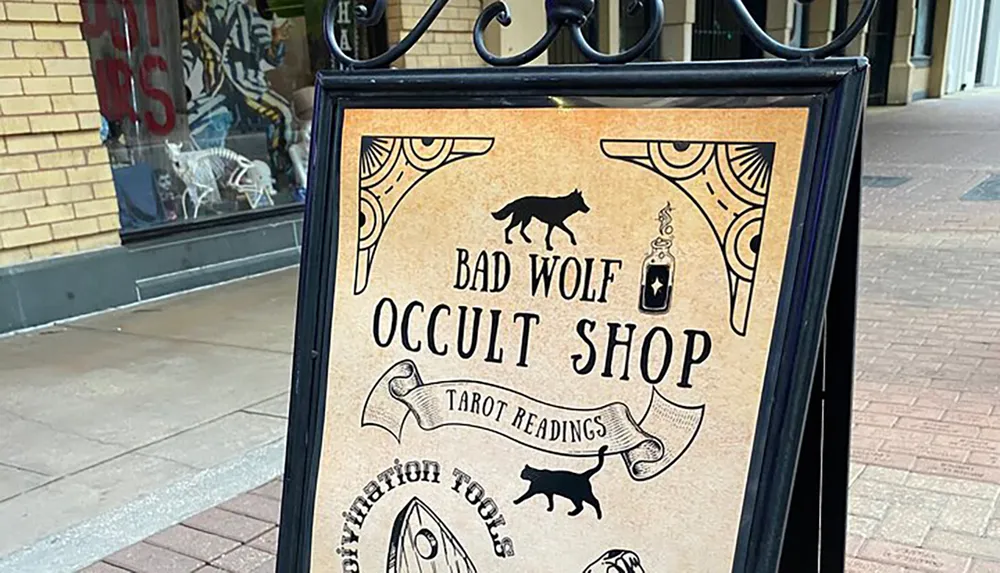 The image shows a signboard for Bad Wolf Occult Shop offering tarot readings and divination tools with mystical symbols and animal silhouettes