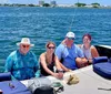 A group of people are enjoying a day of sailing on a multi-hull sailboat on a large body of water