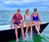 A group of people are enjoying a day of sailing on a multi-hull sailboat on a large body of water