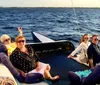 A group of people are sailing on a trimaran enjoying a sunny day on the water