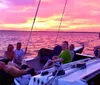 A group of people are sailing on a trimaran enjoying a sunny day on the water