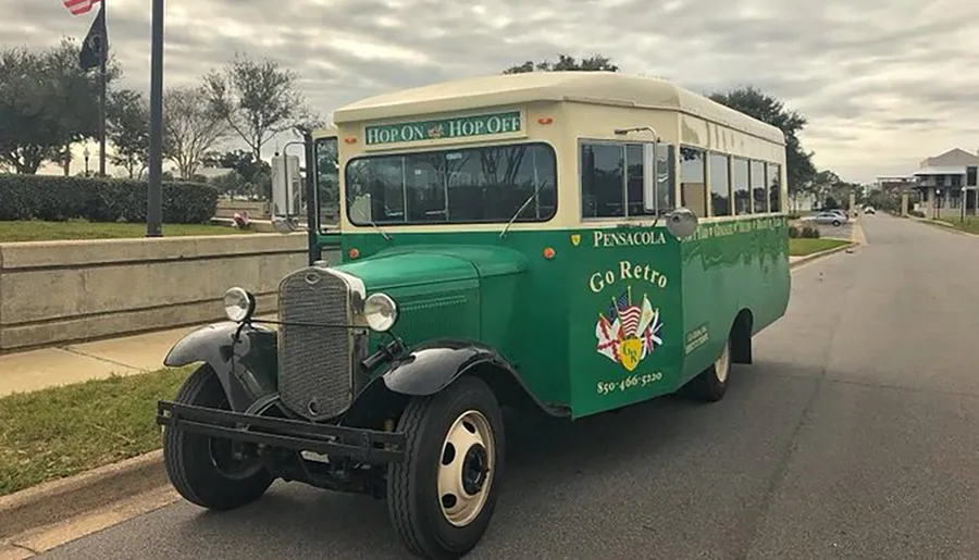 The image shows a vintage-style green bus with Hop On & Hop Off and Pensacola Go Retro branding, parked on a street.