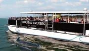 A group of passengers are enjoying a sightseeing cruise aboard 