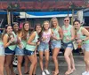 A group of joyful friends are toasting with drinks while enjoying a ride on a pedal pub