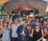 A group of joyful friends are toasting with drinks while enjoying a ride on a pedal pub