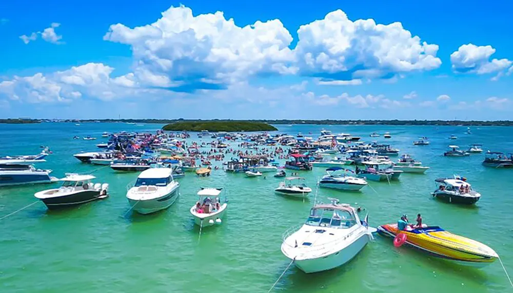 The image shows a vibrant gathering of numerous boats and people enjoying themselves on a sunny day in a clear blue waterbody possibly during a boat party or a marine event