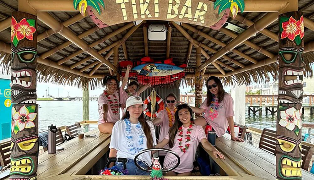 A group of people is enjoying time together on a floating tiki bar adorned with tropical decor