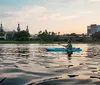 A group of people enjoying a night kayaking activity with illuminated kayaks on a body of water